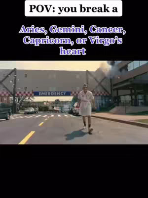 The cover image shows a scene resembling a film still. In the foreground, a person dressed in a white robe walks towards the camera on a paved road, with a building and emergency sign in the background. The color palette features muted tones.