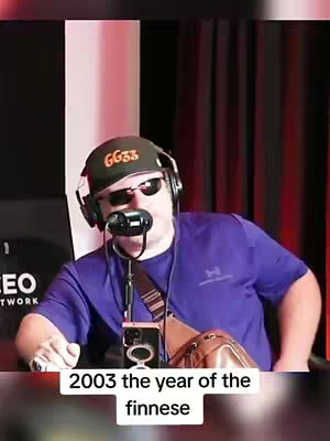 A man wearing sunglasses, a backwards cap, and headphones sits in front of a microphone. Text at the bottom says 2003 the year of the finesse.