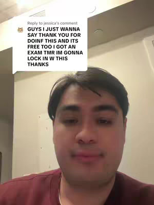 A selfie-style video where a young man is centered in the frame, his expression serious. Behind him is a bright, uncluttered, indoor space possibly an office or a home setting. A comment bubble is overlaid in the top left corner, containing a message.