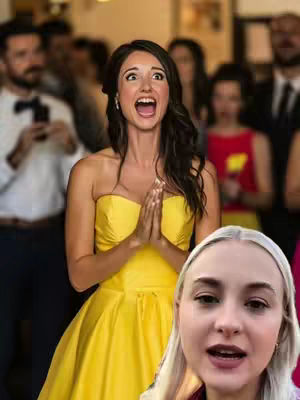 A shot of a wedding with guests in the background and a woman in a yellow dress and a blonde woman smiling while making comments.