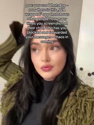 A woman with long black hair is posing for a selfie. She is wearing a black turtleneck and a green jacket. Text overlays the image.