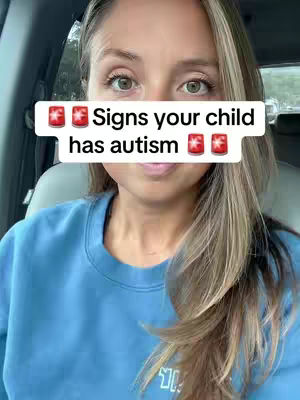 A woman with long blonde hair and a blue sweatshirt sits in a car. A white text box overlays her face, displaying the words 'Signs your child has autism.' The woman has light eyes and is looking at the camera.
