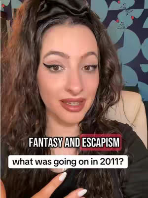 A woman with long, wavy brown hair and dark eyeliner looks at the camera. Text overlays read 'FANTASY AND ESCAPISM' and 'what was going on in 2011?'