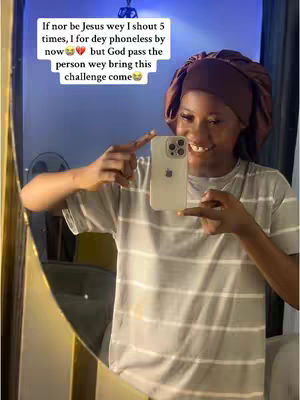 A woman in a striped t-shirt smiles while taking a selfie with her phone in front of a mirror. Overlay text is present.