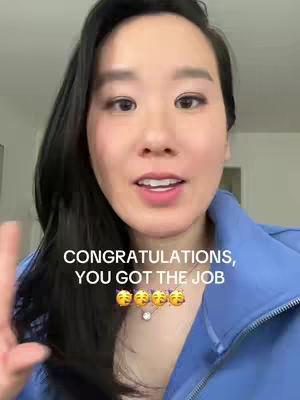 A woman with dark hair and a blue top smiles at the camera, with text overlayed that says "CONGRATULATIONS, YOU GOT THE JOB" with celebratory emojis.  The background appears to be a bright, possibly interior setting.