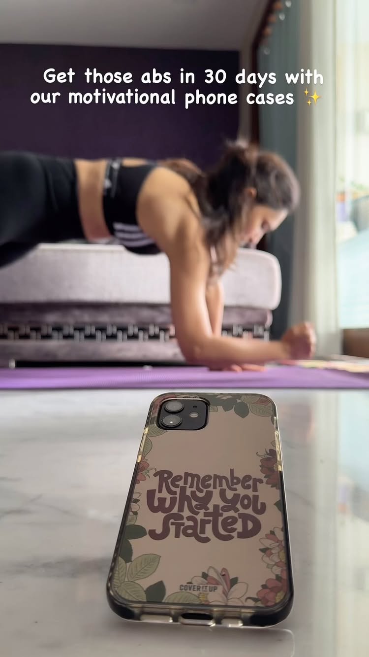 The cover image shows a woman in a plank position on a purple yoga mat, with a phone case in the foreground showing a motivational quote. The background features a blurred room with a couch, a window and a purple wall.