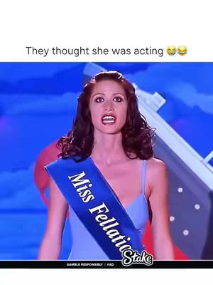 A woman in a blue dress and sash that reads "Miss Fellatio" stands with her mouth open in shock, with a blue background.