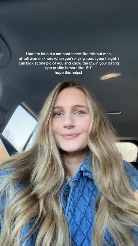 A woman with long blonde hair is seated inside a car. She is wearing a blue denim jacket. Text overlayed on the image provides commentary about dating app profiles and height.