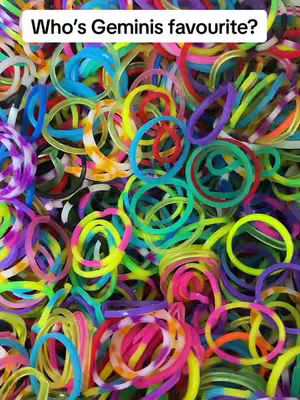 An overhead shot focusing on a pile of colorful rubber bands, showing various colors and overlapping shapes including circles and loops.