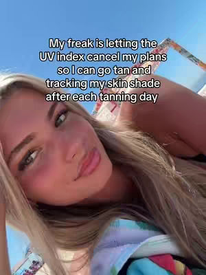 A selfie of a young woman with long blonde hair, looking towards the camera. Text, in a handwritten style font, is overlayed above her head. Behind her is a bright blue sky and the edge of what appears to be a beach accessory.