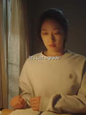 A young woman in a light-colored sweater is the focus, positioned slightly off-center with a soft background. She has a slightly downward gaze, her expression appearing contemplative. The lighting suggests a warm environment. Text overlayed provides context.