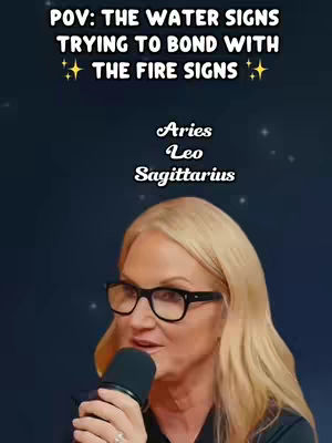 A woman with blonde hair and glasses speaks into a microphone with animated text overlaying the image. The background is a dark blue gradient potentially meant to represent space, with tiny stars. The overlay text indicates the video's focus on astrology and zodiac signs.