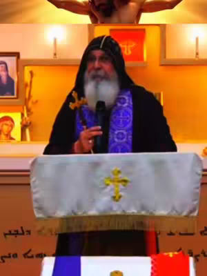The cover image shows a man, presumably a religious figure, giving a speech at a podium behind which a cross can be seen. The foreground shows a podium draped in a white cloth with a cross design. A flag provides color to the foreground the man is wearing religious garments.