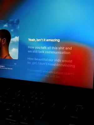 The cover image shows a laptop screen displaying lyrics from the song "Connect" by Drake. The screen has a blue and red gradient background. On the left side, there's an image that partially shows Drake’s face. Over laid in white text, the lyrics start with "Yeah, isn't it amazing"