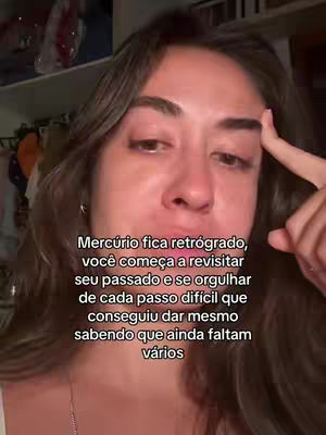 A medium shot shows a young woman looking at the camera, seemingly deep in thought, with her right index finger touching her temple. Text is overlayed in white, centered near the bottom of the frame. The background is a cluttered room with an open closet visible.
