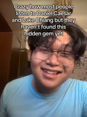 A selfie-style shot featuring a young man with glasses smiling. Text overlays at the top of the frame.