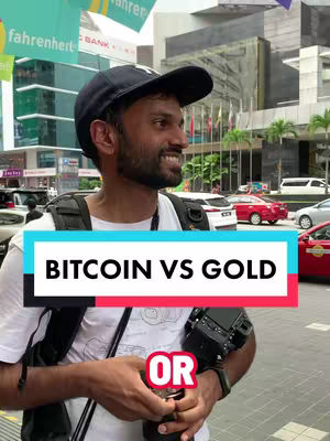 A man wearing a black cap and backpack is standing on the street, holding a camera. Text overlays reading 'BITCOIN VS GOLD' and 'OR' are present. The background shows buildings and street scenes, suggesting an urban setting.