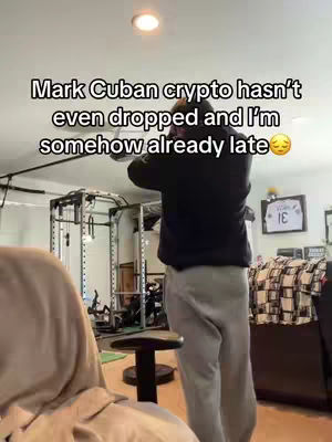 A person, likely the content creator, stands in what appears to be a home gym setting, viewed from roughly the waist up. The person is facing away from the camera and is wearing a black jacket, and gray sweatpants. There are gym equipments in the background.