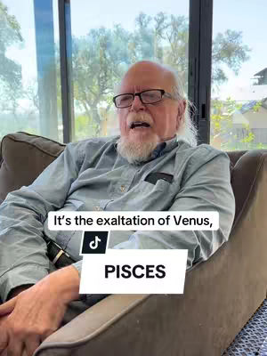 An older man with glasses and a white beard sits in a chair in front of a window. Text overlays say "It's the exaltation of Venus, PISCES".