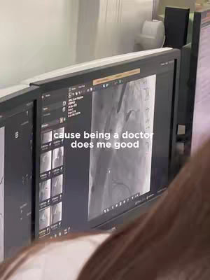 A person is shown partially, their hair visible, with an over-the-shoulder view of two computer monitors displaying medical imaging. Text overlayed says cause being a doctor does me good.