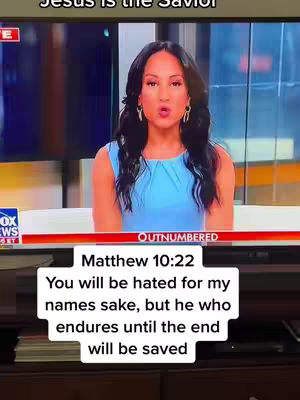 A woman with dark hair and a blue dress is speaking in front of a television screen. Text overlays on the screen include a Bible verse.