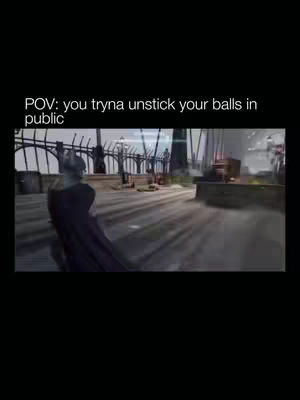A video game scene with a figure in a black cape walking away from the camera in a public space. Text overlays appear on the top left of the frame.