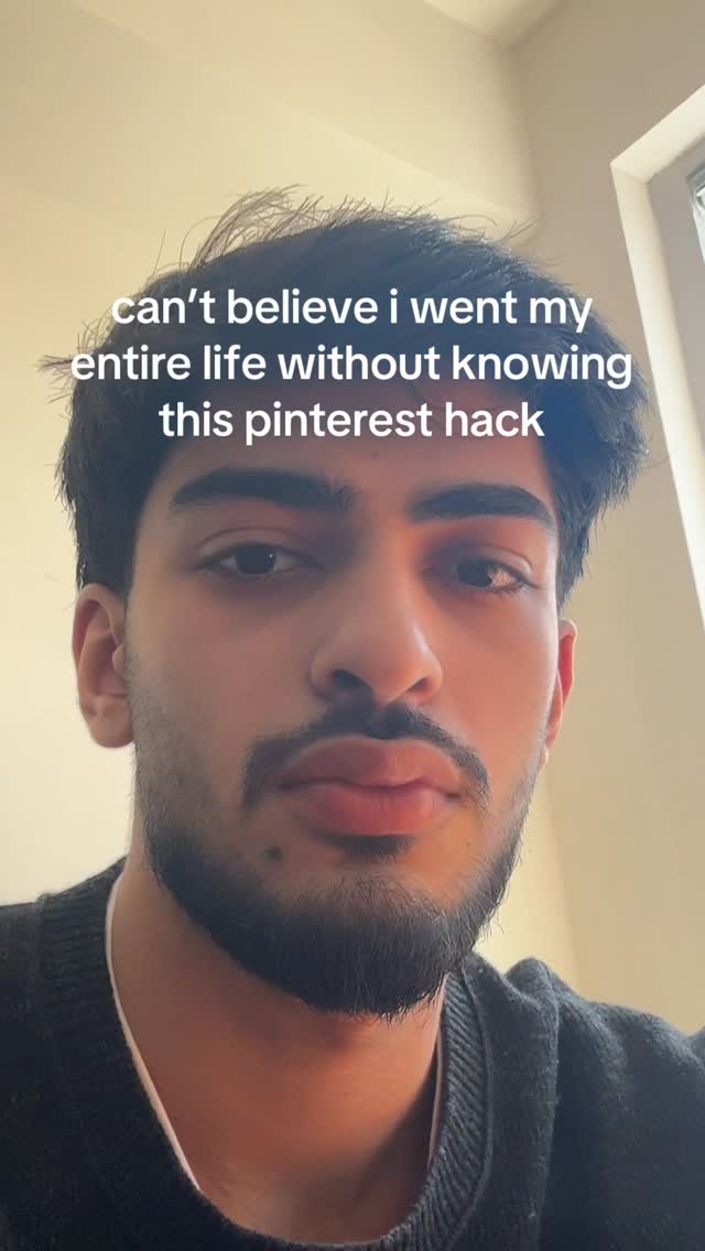 A selfie-style shot featuring a young man, viewed from the chest up, against a neutral background. He has dark hair and a neatly trimmed beard and mustache. Text overlayed on the image says, “can’t believe i went my entire life without knowing this pinterest hack.”