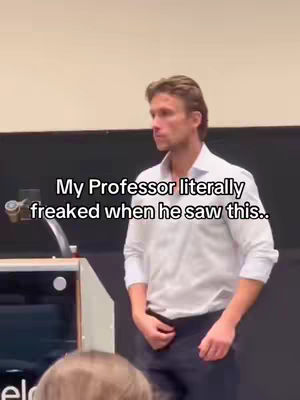 A man in a white shirt stands on a stage in front of a screen. Text overlayed on the image says, 'My Professor literally freaked when he saw this..'