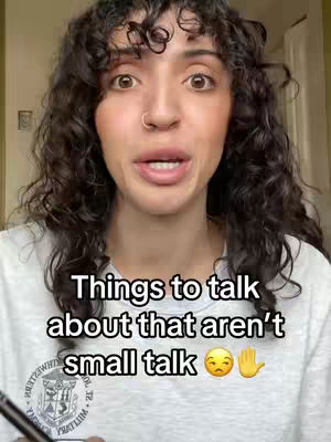 A woman with curly dark hair and a nose ring looks directly at the viewer, eyes wide. Text overlays the image, along with emoji.
