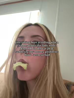 A selfie-style shot features a young woman indoors, her face filling most of the frame. She has long, blonde hair and is captured with a slightly upward angle. Her expression is somewhat obscured, as she has a piece of food in her mouth. Above her, overlaid text is visible.