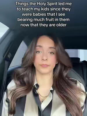 A medium shot shows a woman in the front seat of a car, facing forward. She has long brown hair. Text is overlaid at the top, and the overall color scheme is natural with a focus on the woman's face and upper body.