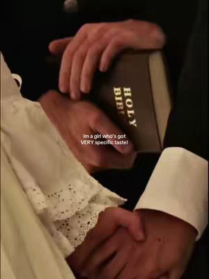 The image shows two people holding hands with a Bible in their hands. The person on the left is wearing a white dress with lace, and the one on the right a black suit. The text overlay states 'im a girl who's got VERY specific taste!'