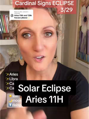 A woman with curly blonde hair is centered in the frame, looking towards the camera and speaking. Overlayed text announces the astrological topic: Solar Eclipse, Aries 11H. Background elements hint at a home setting, with shelves and objects softly blurred.