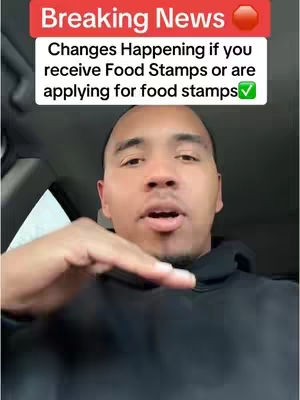 A man is centered in the frame, looking towards the camera and gesturing with his right hand. Above him, a text overlay in a red banner reads "Breaking News". Below this, white text on a gray background provides detail related to food stamps with a green checkmark.