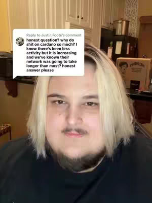 The cover image is a selfie. A person with blonde hair and a slight beard is in the center of the image. They are wearing a black t-shirt and a speech bubble is in the top left of the frame, showing the text from a comment on Cardano.