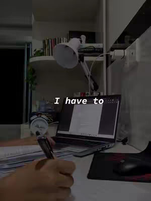 The cover image shows a person's hand writing on paper, with a laptop, desk lamp, and bookshelf in the background. Text overlayed.