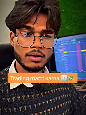 A young man with glasses is centered in the frame, looking towards the camera. A text overlay in an orange rectangle is at the bottom of the screen, on top of his dark sweater in front of a screen.