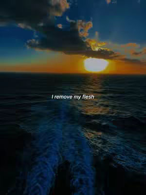 A vibrant sunset over the ocean. The sky is a blend of orange, yellow, and blue, with clouds. The ocean water has visible waves and the sun is almost hidden behind the clouds. A water trail is visible.