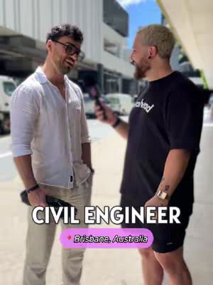 Two men are pictured standing in an outdoor setting. The man on the left is wearing a white button-down shirt and khaki pants, with sunglasses pushed to the top of his head. He has dark hair and glasses. The man on the right is wearing a black t-shirt and shorts and has short, bleached blonde hair and a beard. Both men are holding microphones and smiling. The text overlay indicates that the Civil Engineer's location is Brisbane, Australia.