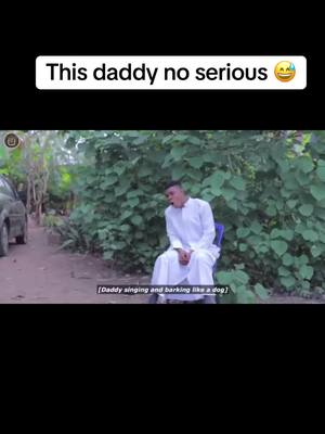 An outdoor scene featuring a man in a white robe seated on a blue chair. Behind him is lush greenery and a glimpse of a vehicle. The text overlay at the top says 'This daddy no serious' with a laughing emoji.