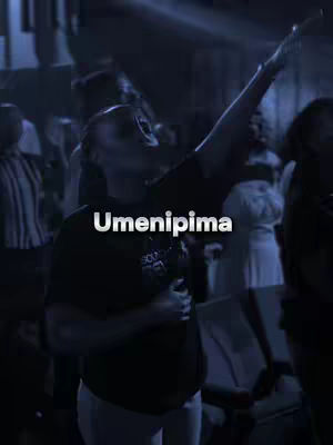 A person with their arms raised in an expression of worship, the image is dark and blue-toned, with the text 'Umenipima' overlaid in white.