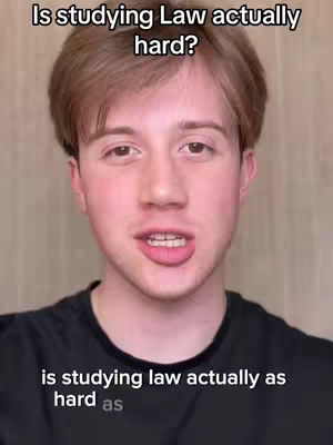A young man with light brown hair and a black shirt is centered in the frame, looking toward the viewer and speaking. Above him, text asks if studying Law is hard. Below, more text reads 'is studying law actually as hard as'. The background is a plain, light color.
