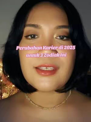 The cover image features a close-up of a woman's face. She has dark hair, makeup, and is wearing a gold necklace. Text overlayed on the image states, "Perubahan Karier di 2025 untuk 3 Zodiak Ini" in a pink font.
