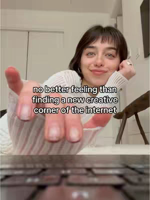 A young woman reaches towards the viewer, her hand extended. Text overlayed on the image reads, 'no better feeling than finding a new creative corner of the internet.' The background is blurred, but appears to be a well-lit interior.