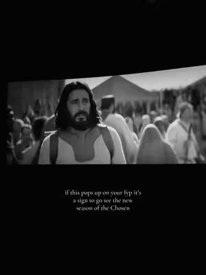 A black and white still from a video featuring a man with a beard and long hair in a historical setting. Text in white at the bottom of the frame overlays the scene.
