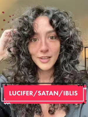 A woman with curly dark hair is centered in the frame, smiling slightly. A red rectangular box at the bottom features the text 'LUCIFER/SATAN/IBLIS'. The background is softly blurred.