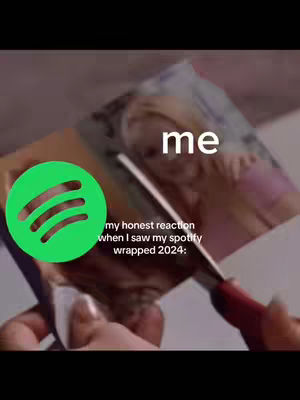 The cover image captures a meme-like scene with a pair of scissors cutting a printed image of a woman, suggesting a sense of rejection or disappointment. A large green Spotify logo is placed in the lower left corner and the text 'me' is superimposed above the woman on the photo. Text in the image reads 'my honest reaction when I saw my spotify wrapped 2024:'. The overall aesthetic is informal and self-referential, indicating a commentary on personal music preferences and Spotify's annual recap feature.