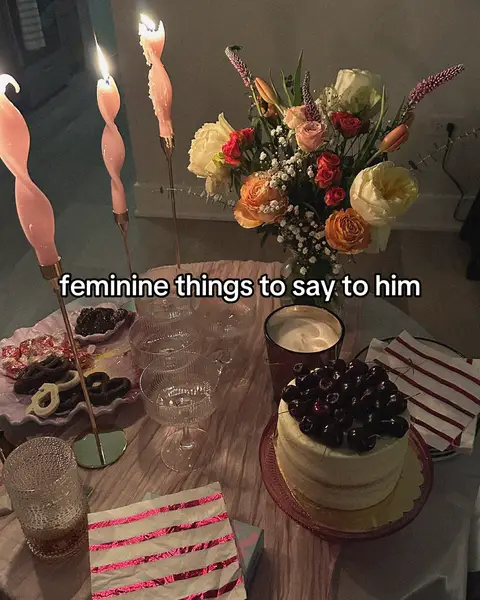 The cover image displays a romantic and sweet setting. In the foreground, a table is set with various elements, including pink candles, a bouquet of flowers, champagne glasses, a cake topped with cherries, and decorative napkins. The color palette is soft and inviting, dominated by pinks, whites, and touches of green and red from the flowers and cherries, suggesting a celebratory event.
