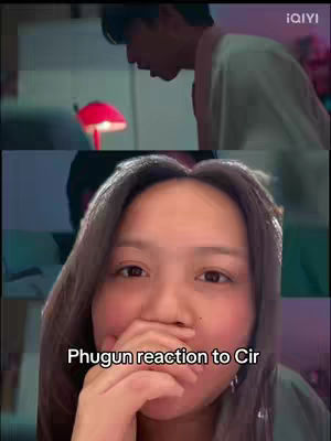 The cover image is a split screen. The upper half displays a man looking down, and the background has blurred colors of pink and green. The bottom half showcases a woman looking directly at the camera, covering her mouth with one hand. Text at the bottom reads "Phugun reaction to Cir".