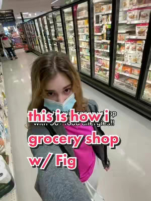 The cover image shows a young woman wearing a face mask standing in a grocery store aisle. The layout is dominated by the woman herself and grocery store shelves. The woman appears to be holding a camera so she is most likely taking a selfie. The focus is on the products in the store with the woman overlaid in the foreground.